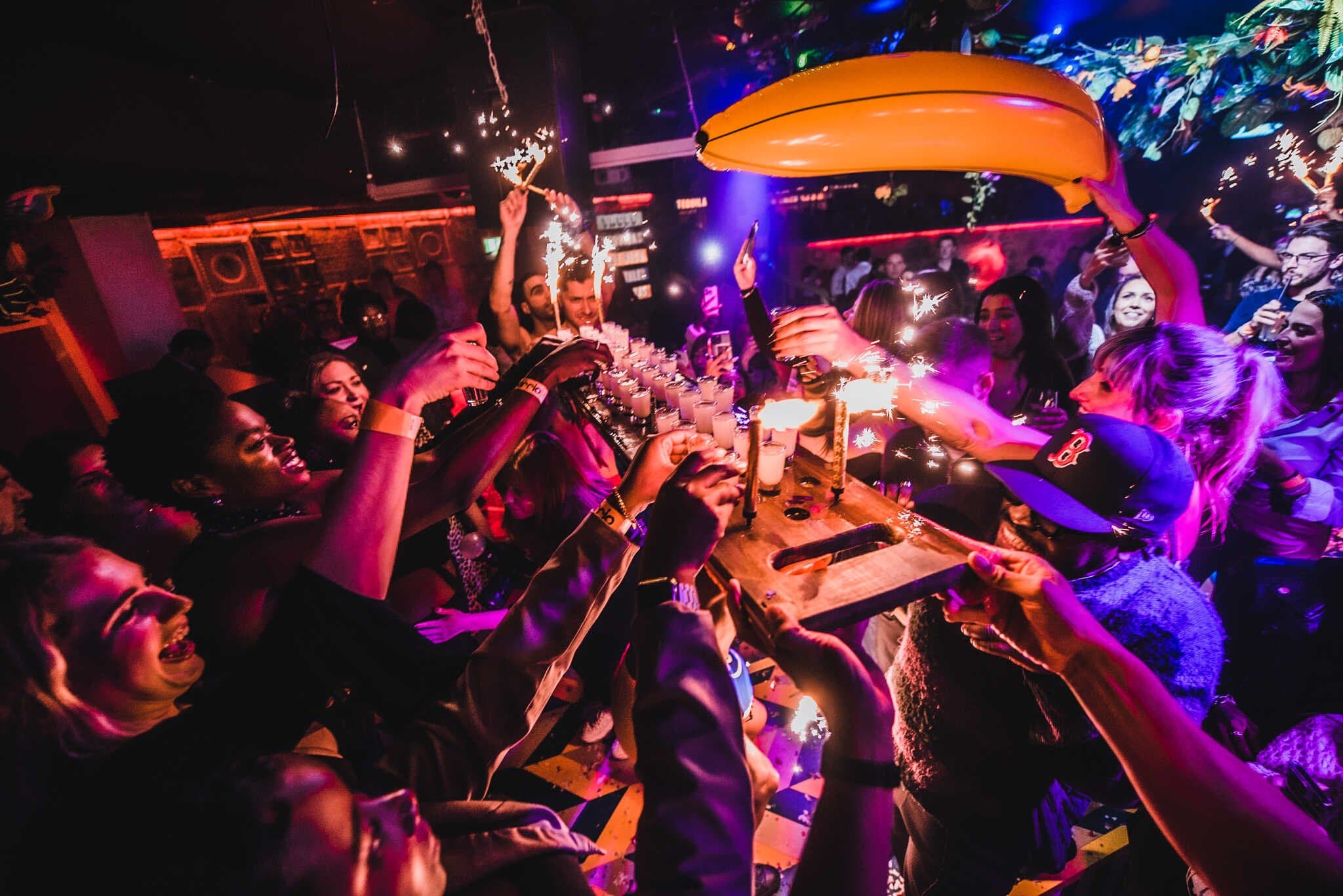 Customers Drinking from a shot board at Barrio Bars