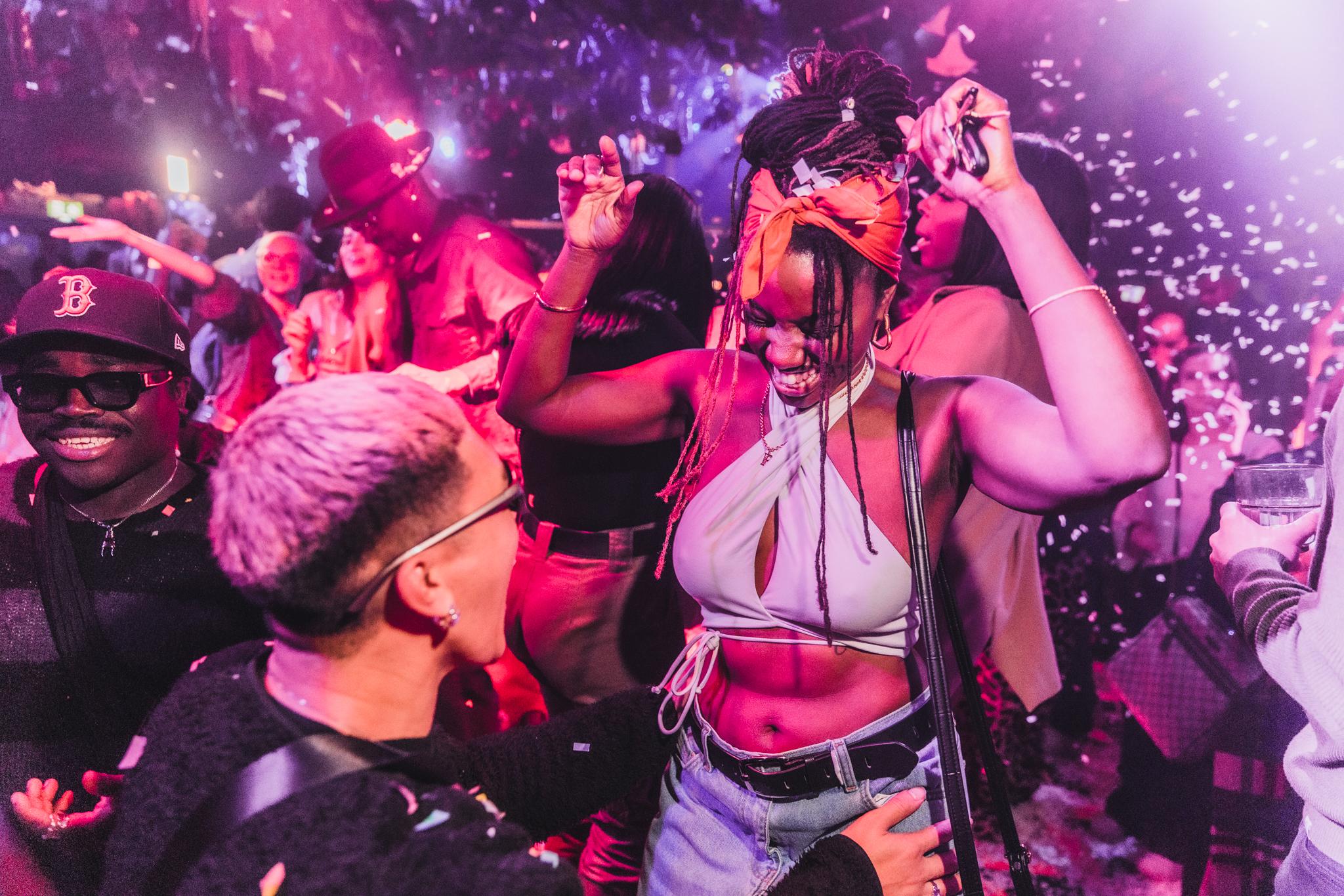 A woman and man dancing in a busy bar